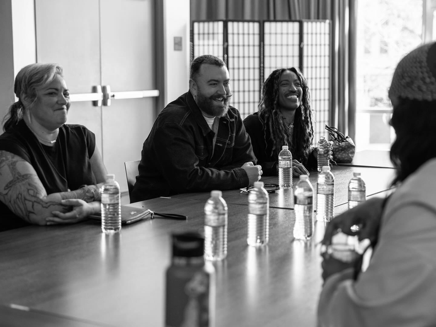 A group of people sitting around a table in a bright room